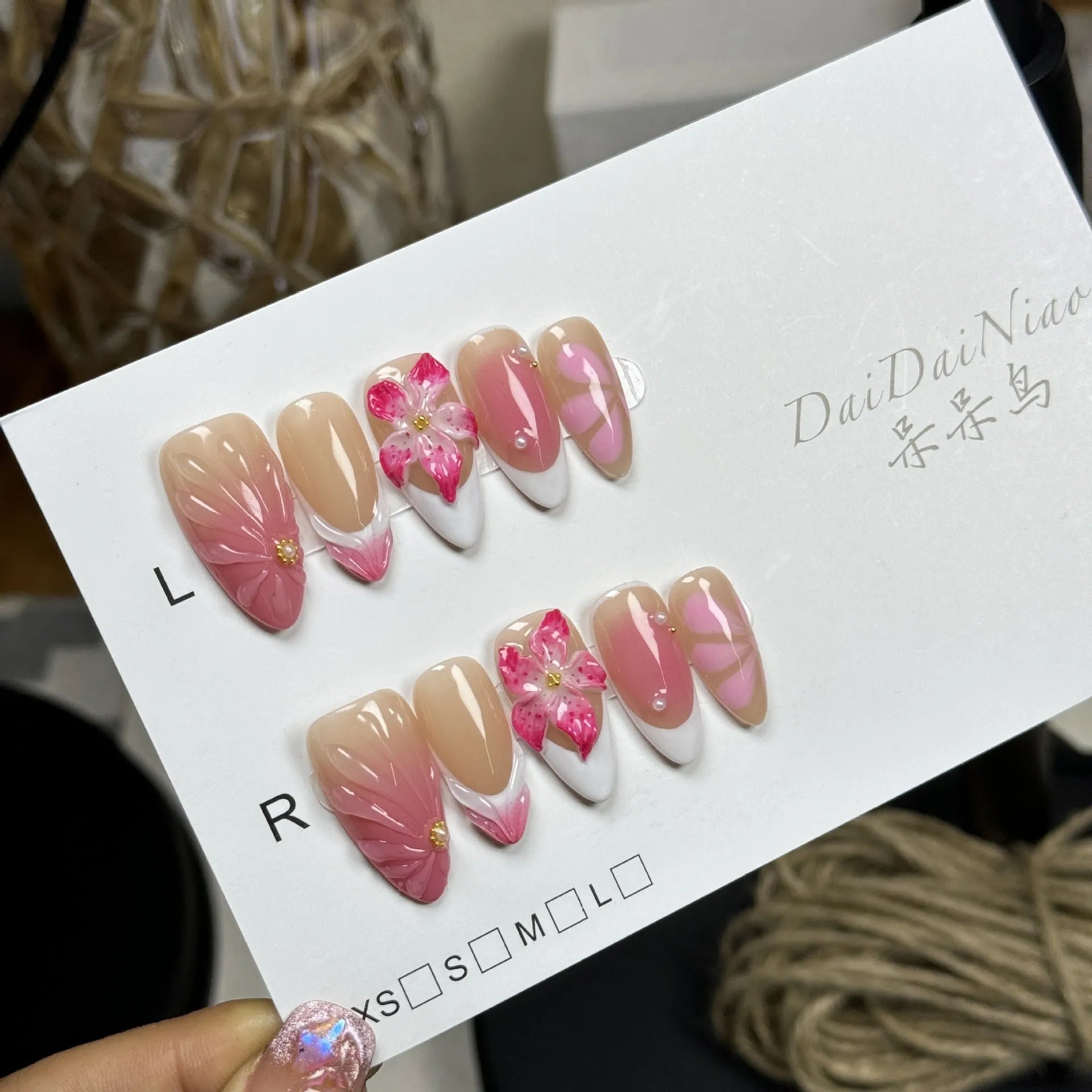 French style artificial nails with three-dimensional fluid ice flower designs on almond-shaped plastic tips