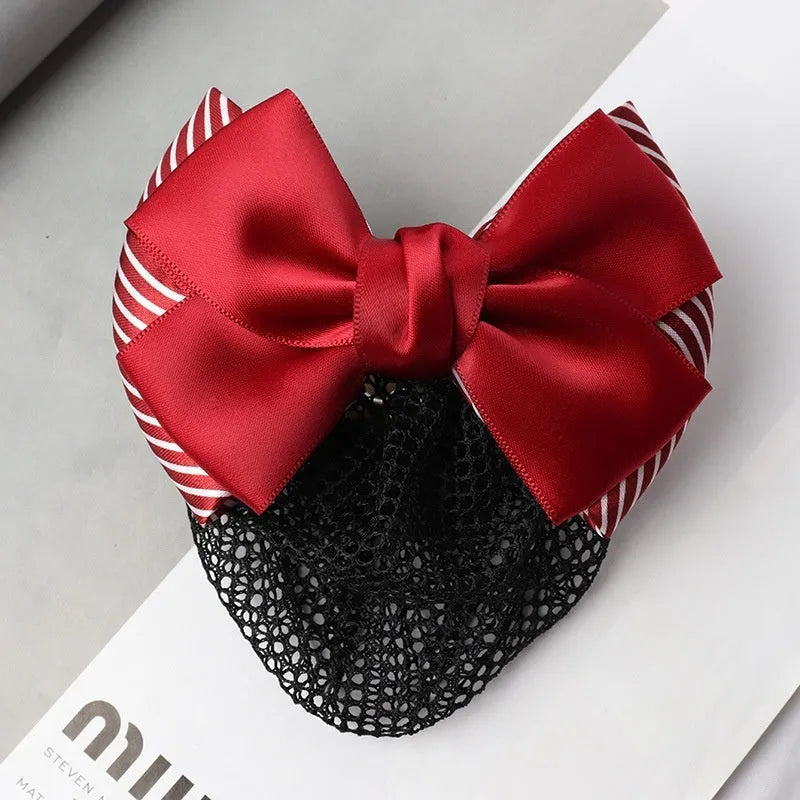 Professional flower bow headdress hair clip ornament on a work plate, shown in a selection of net and mesh colour variations.