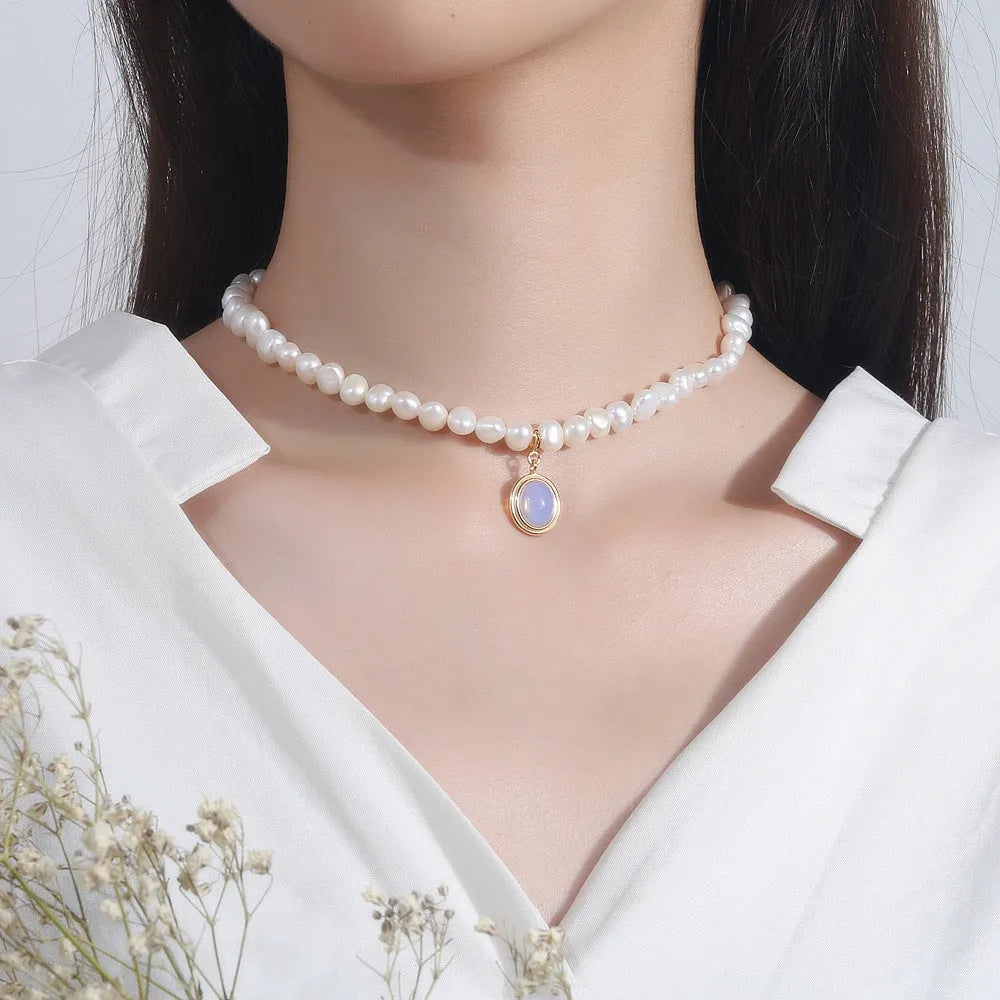White geometric pendant on an adjustable sterling silver necklace chain.