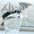 Small leather dog collar with decorative devil wings and bell in patent leather satin