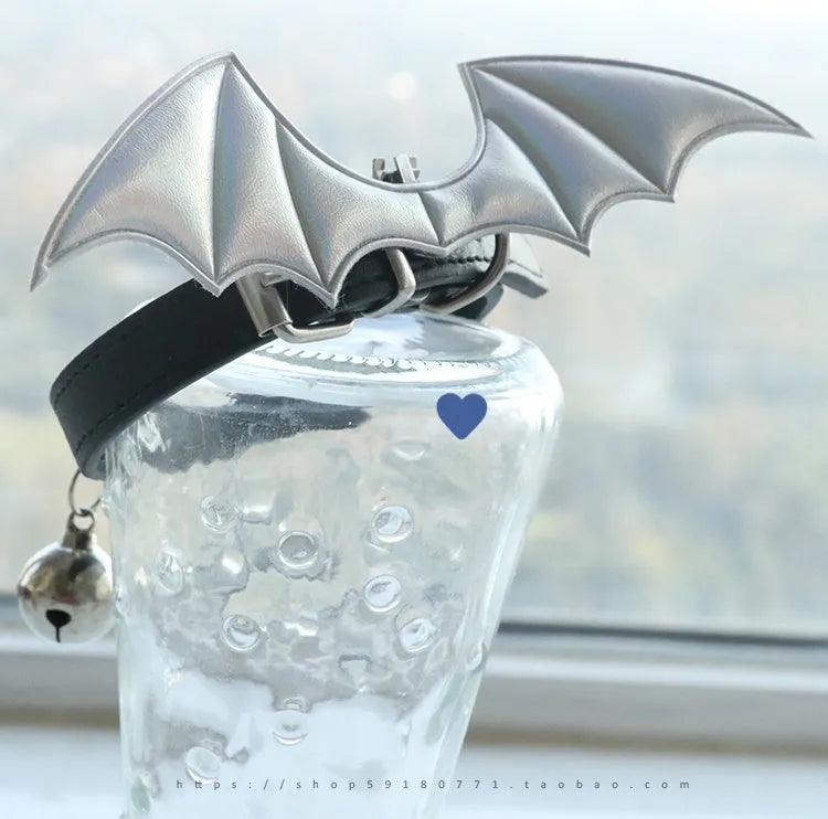 Small leather dog collar with decorative devil wings and bell in patent leather satin