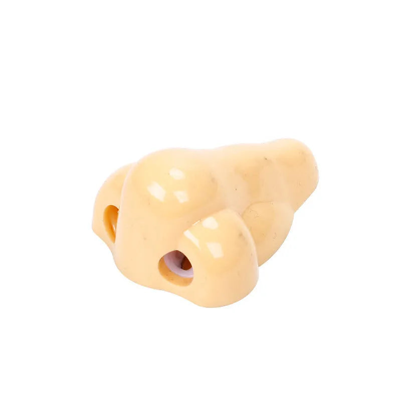 Flesh colour plastic pencil sharpener with geometry shape measuring 58x45x30 mm