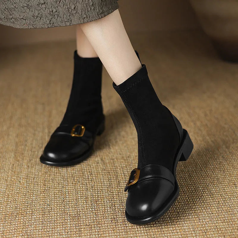 Black women's low heel Martin ankle boots with front lace-up and metal buckle detail on a white background.