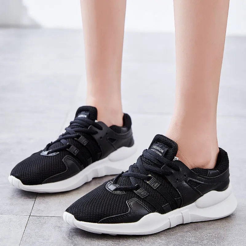 Side view of black hollow breathable mesh sneakers with flat EVA sole and round toe design