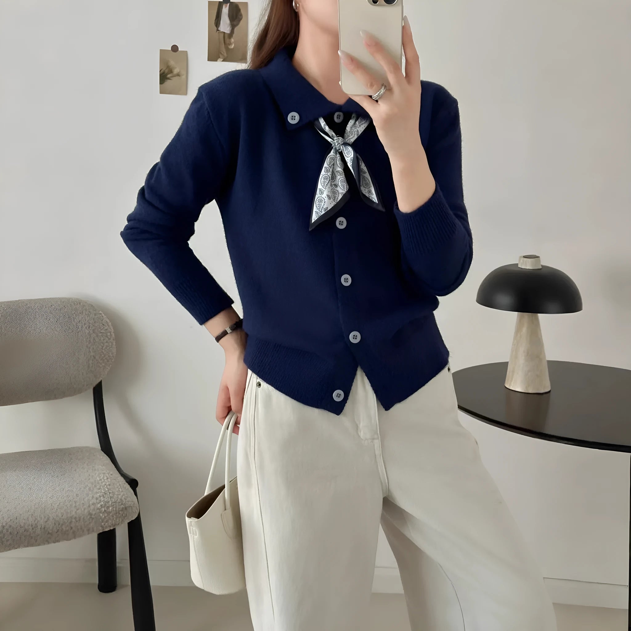Beige cardigan sweater with attached lapel scarf and long sleeves on a model.