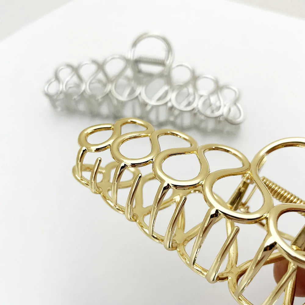 Large alloy hair clip with gold electroplated finish and irregular tassel detail
