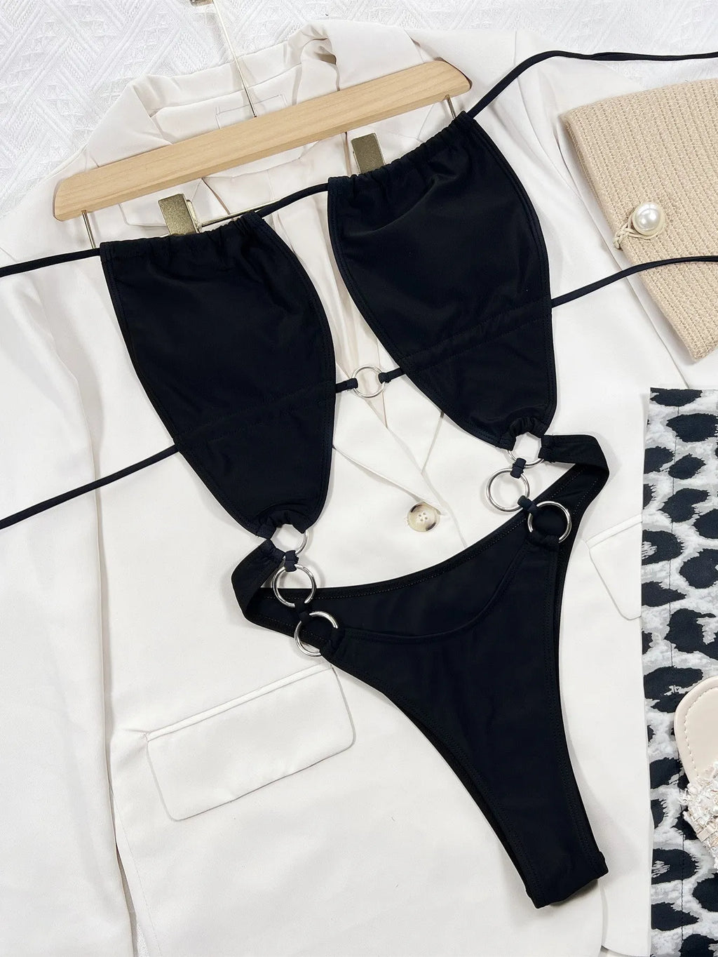Solid black women's one-piece sleeveless swimsuit made from nylon fabric.