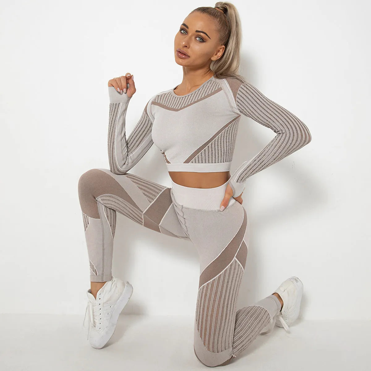 Woman wearing a long-sleeved seamless knitted yoga wearsuit in a stripe pattern, demonstrating a yoga pose.