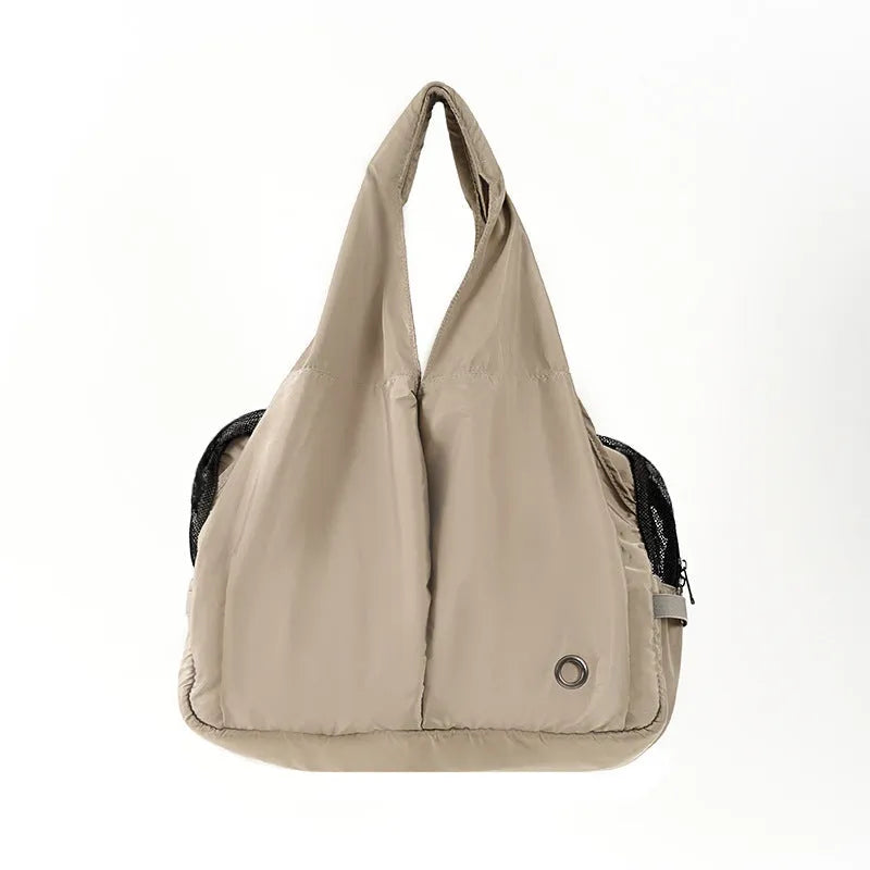 Apricot coloured cloth pet handbag for outdoor summer use.