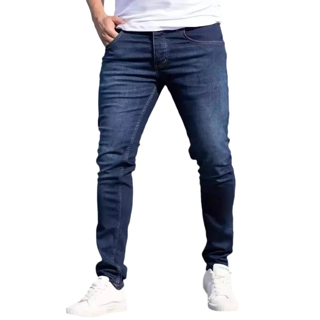 Men's slim fit dark blue jeans with skinny leg design and mid waist cut