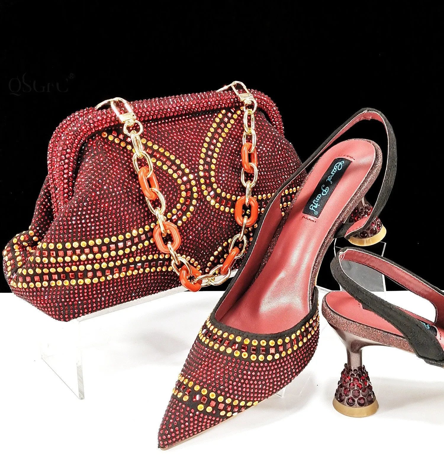 Women's pointed-toe high heel shoes with matching bag, featuring a stiletto heel and rhinestone detail on a synthetic leather upper.