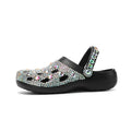 Black women's platform sandals covered in rhinestones with a chunky EVA sole.