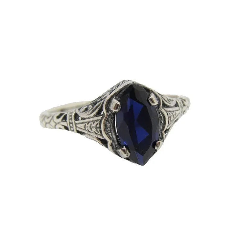 Women's silver geometric hollow ring showing alloy construction and detailed pattern