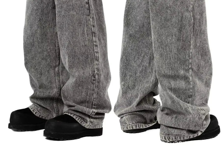 Grey loose fit straight-leg denim trousers with mid-waist design on a hanger