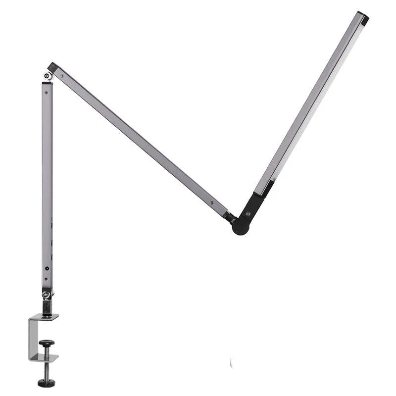 Black adjustable clip-on desk lamp with flexible arm and remote control on a wooden desk