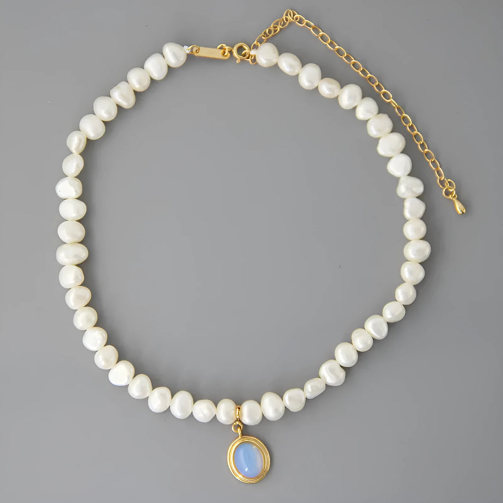 White geometric pendant on an adjustable sterling silver necklace chain.