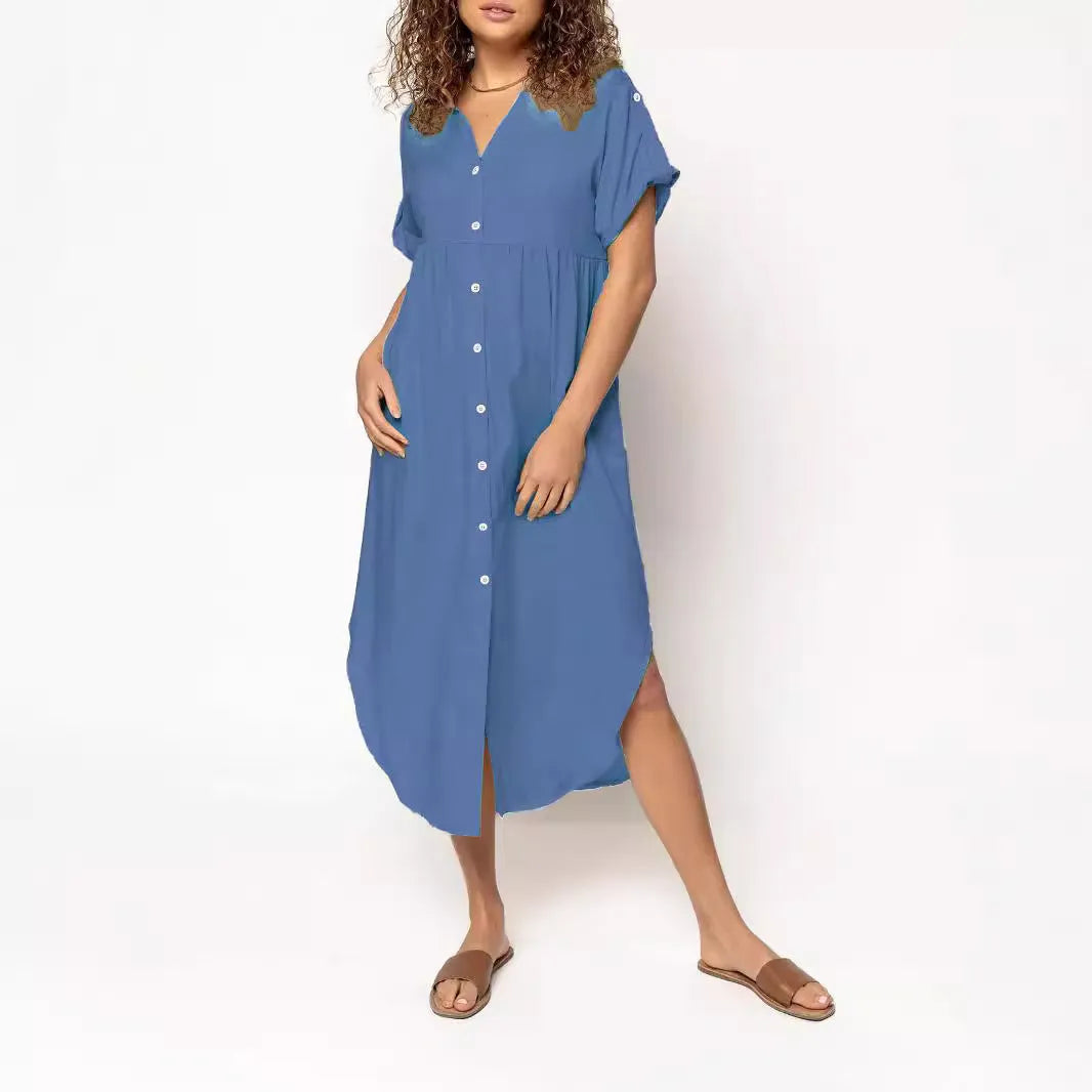 A loose-fitting, solid colour mid-length casual dress with a button-down front and regular sleeves.