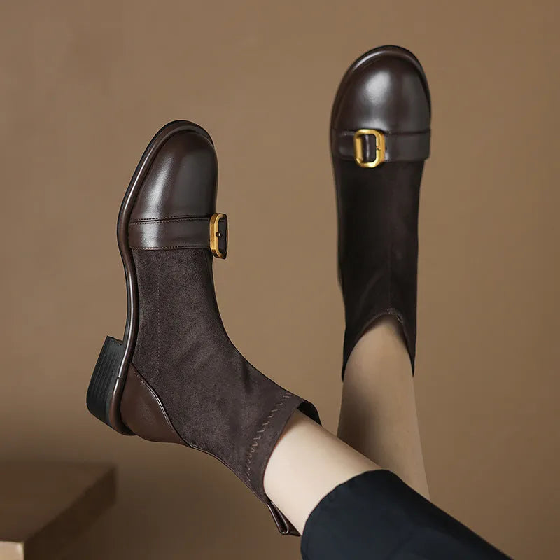 Black women's low heel Martin ankle boots with front lace-up and metal buckle detail on a white background.