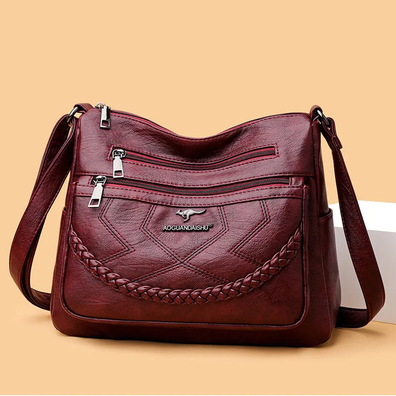 Soft PU leather shoulder bag in horizontal square shape, shown in one of four colours with crossbody strap