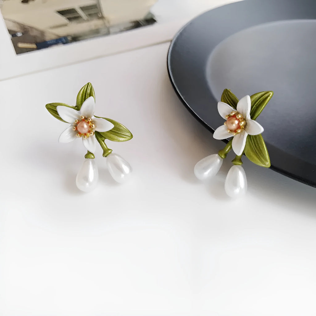 Women's alloy flower earrings set showing sterling silver needle flower studs and matching flower ear clip pair