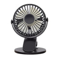 White USB rechargeable mini clip fan with plastic blades attached to a stroller handle.