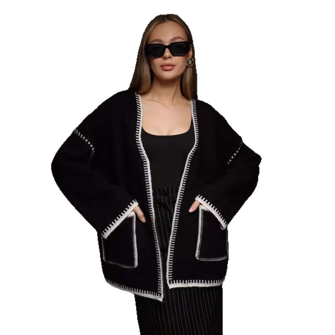 Loose fit knitted cardigan sweater coat in camel colour, showing long sleeves and mid-length hem.