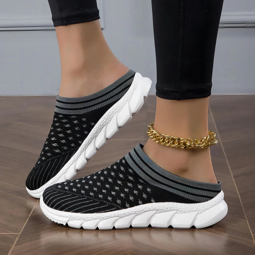 Women's black Flyknit slipper shoes with striped pattern and hollowed-out design on a lightweight viscose sole.