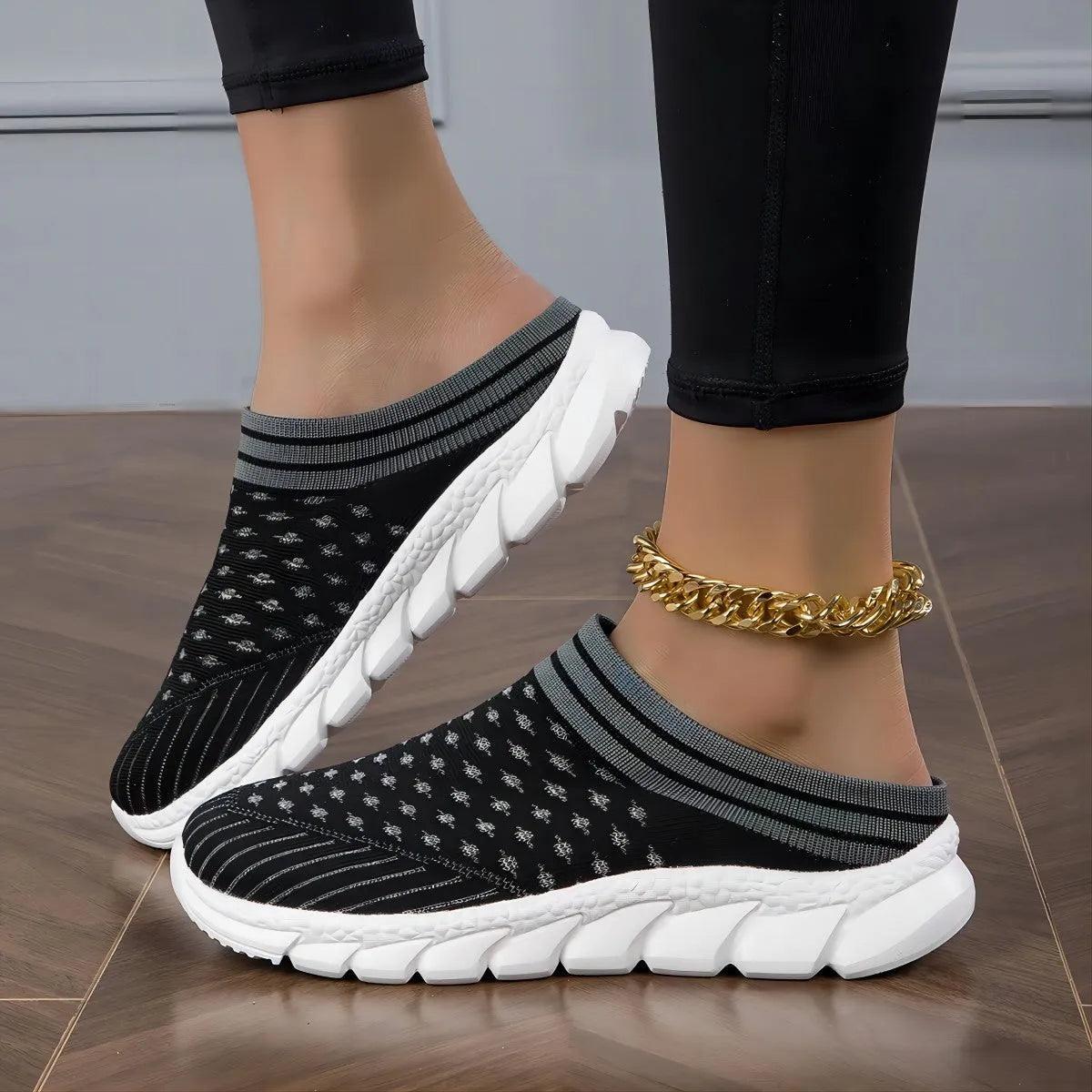 Women's black Flyknit slipper shoes with striped pattern and hollowed-out design on a lightweight viscose sole.