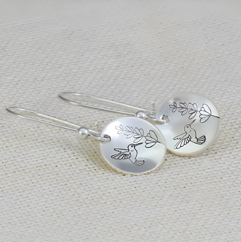 Women's silver bird motif earrings with leaf accents and glossy round components