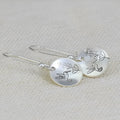 Women's silver bird motif earrings with leaf accents and glossy round components