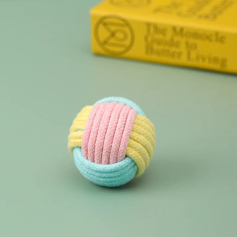 Handmade cotton plush cat toy in blue pink green colours measuring 5cm diameter
