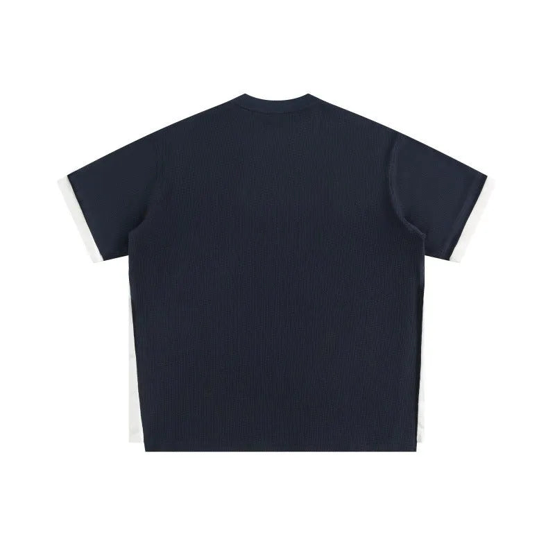 Retro alphabet embroidered loose waffle short-sleeved t-shirt in navy blue, front view.