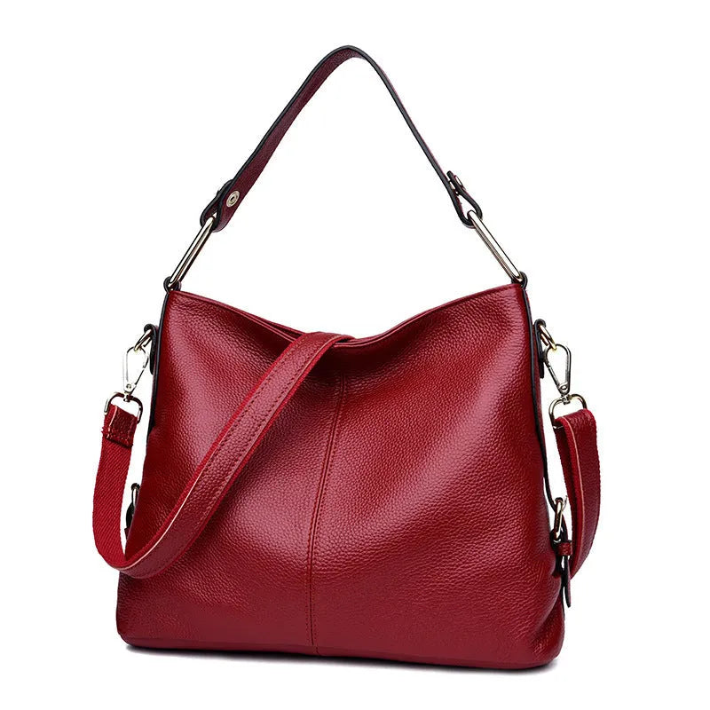 Genuine leather women's crossbody bag in square vertical design, showing internal zipped phone and document pockets.