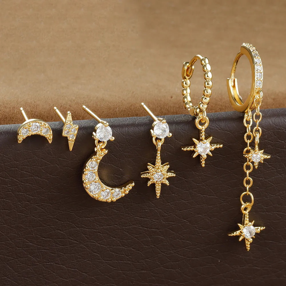 Six pairs of gold electroplated chain tassel earrings with zircon studs on display
