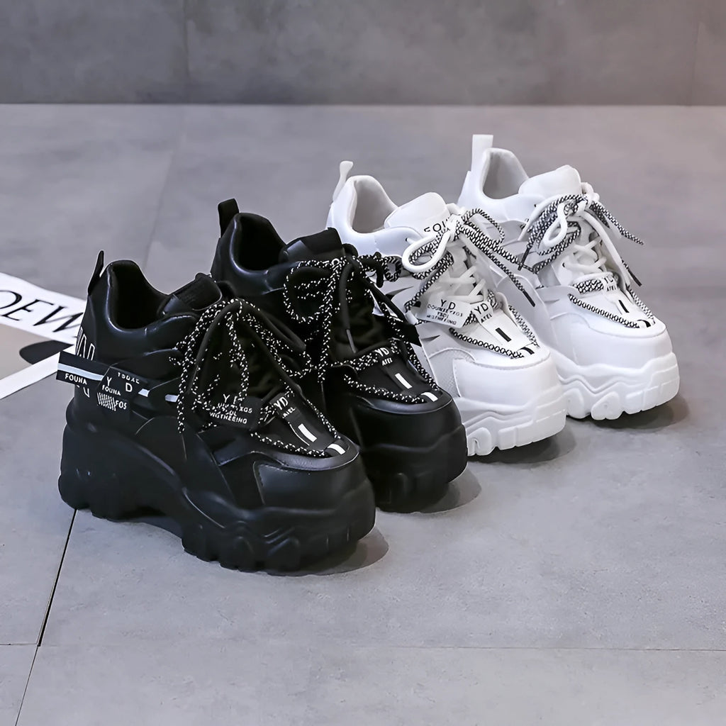 Women's white and black mesh platform sports shoes with cross-strap detail and rubber soles