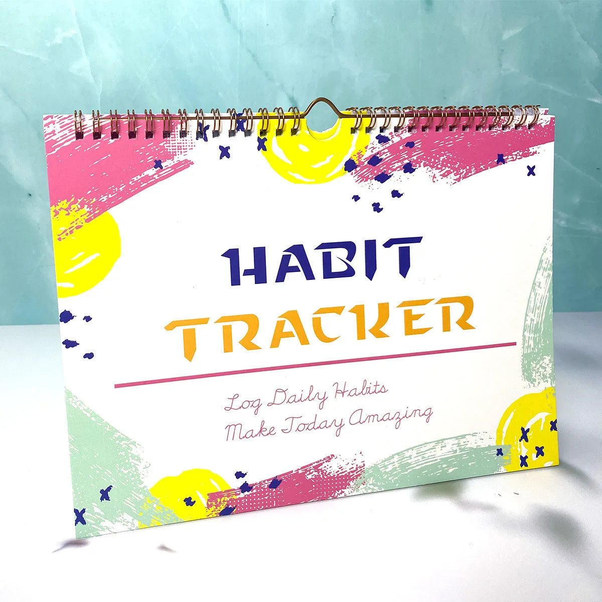 Habit tracking device showing 12 internal pages for schedule planning in various colour options