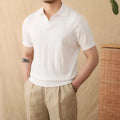 Man's purple short sleeve polo shirt with seagull collar and sunken stripe knitted texture.