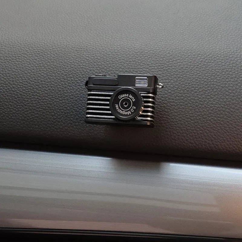Set of four retro camera dot design plastic adhesive hooks for car dashboard organisation.