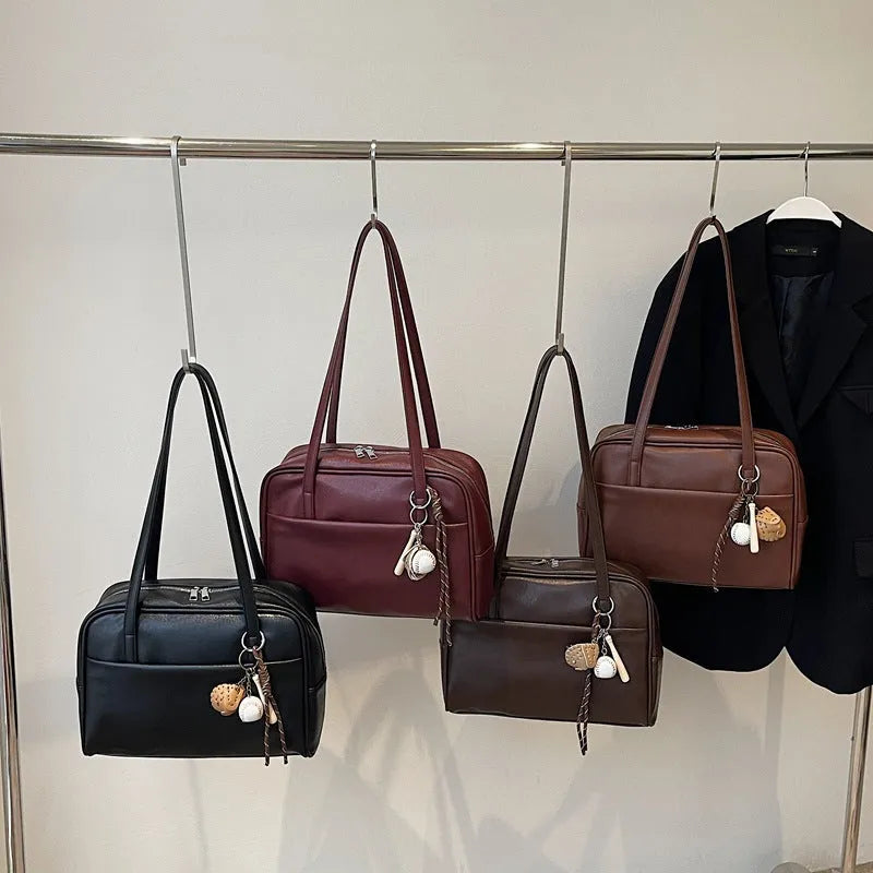 Women's urban simple PU bucket underarm bag with pendant detail in black, brown, coffee, and wine red colours.