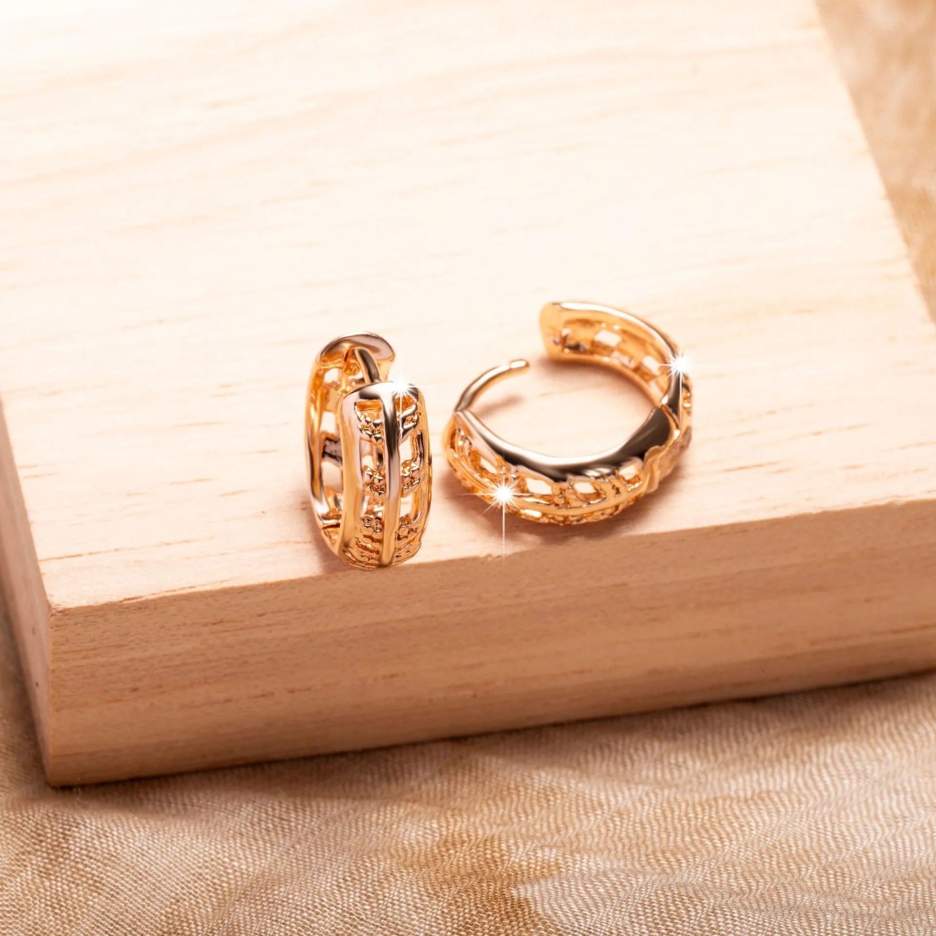Rose gold hollow leaf earrings with a heart detail, made from copper.