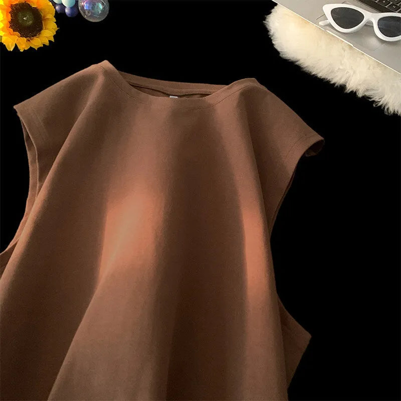 Men's solid colour loose fit cotton tank top on a hanger, showing straight hem and sleeveless design.