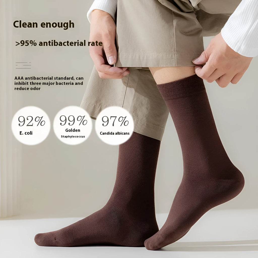 Mid-calf men's socks in solid colours made from combed cotton, shown in a stack.