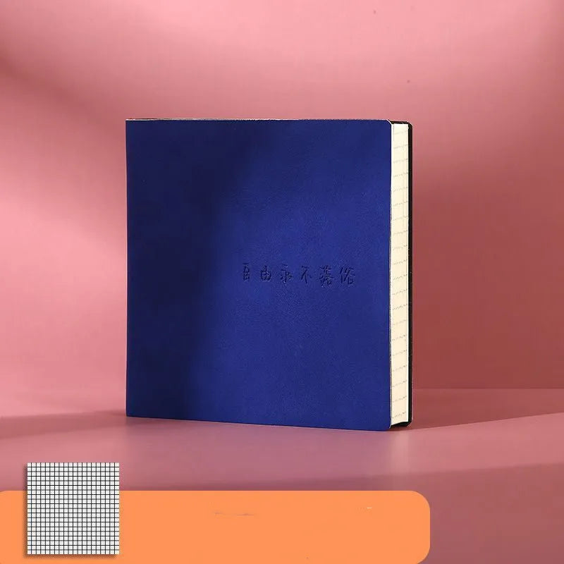 Square notebook with textured faux leather cover showing French fold binding and open blank pages