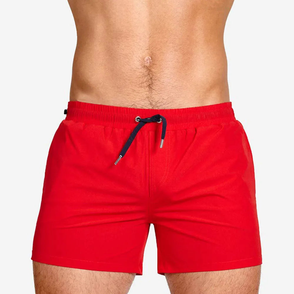 Men's solid colour polyester sports shorts with mesh lining, shown in Army Green, for swimming and fitness.