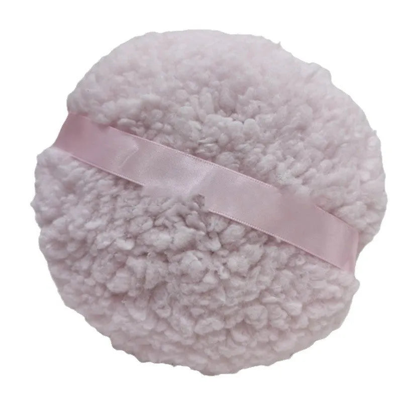 Oversized rectangular plush powder puff for makeup application in pink, white, or skin colour.