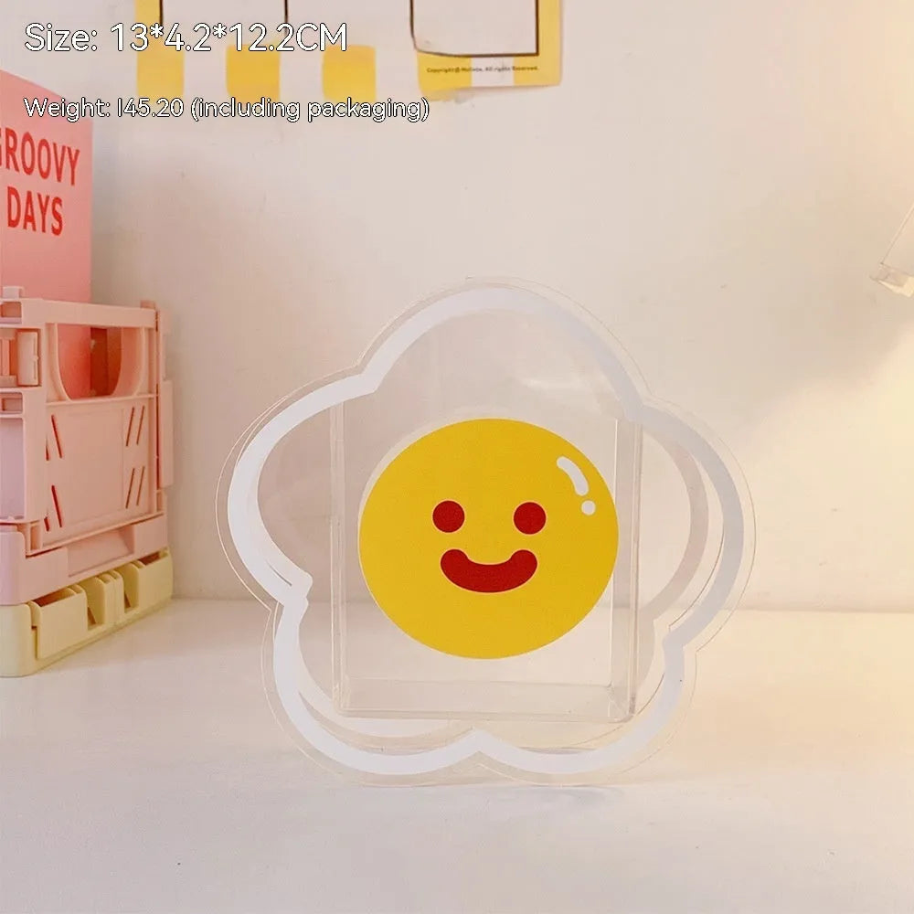 Clear square acrylic storage box with a cute decorative pattern, for stationery on a desk.