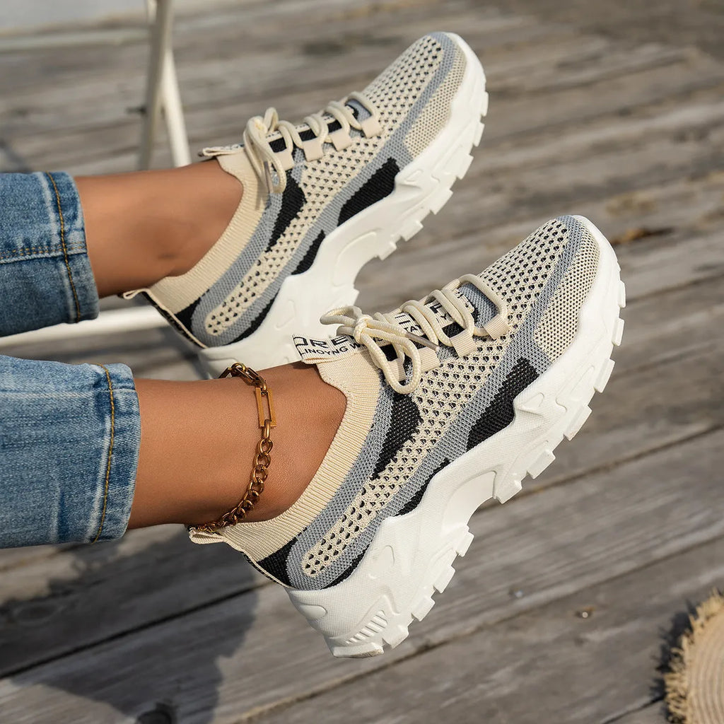 Women's Flyknit lace-up sneakers in a selected colour with a low rubber sole and round toe