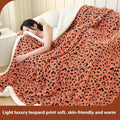 Double-layer cationic leopard jacquard taffeta blanket showing leopard print pattern in camel colour.