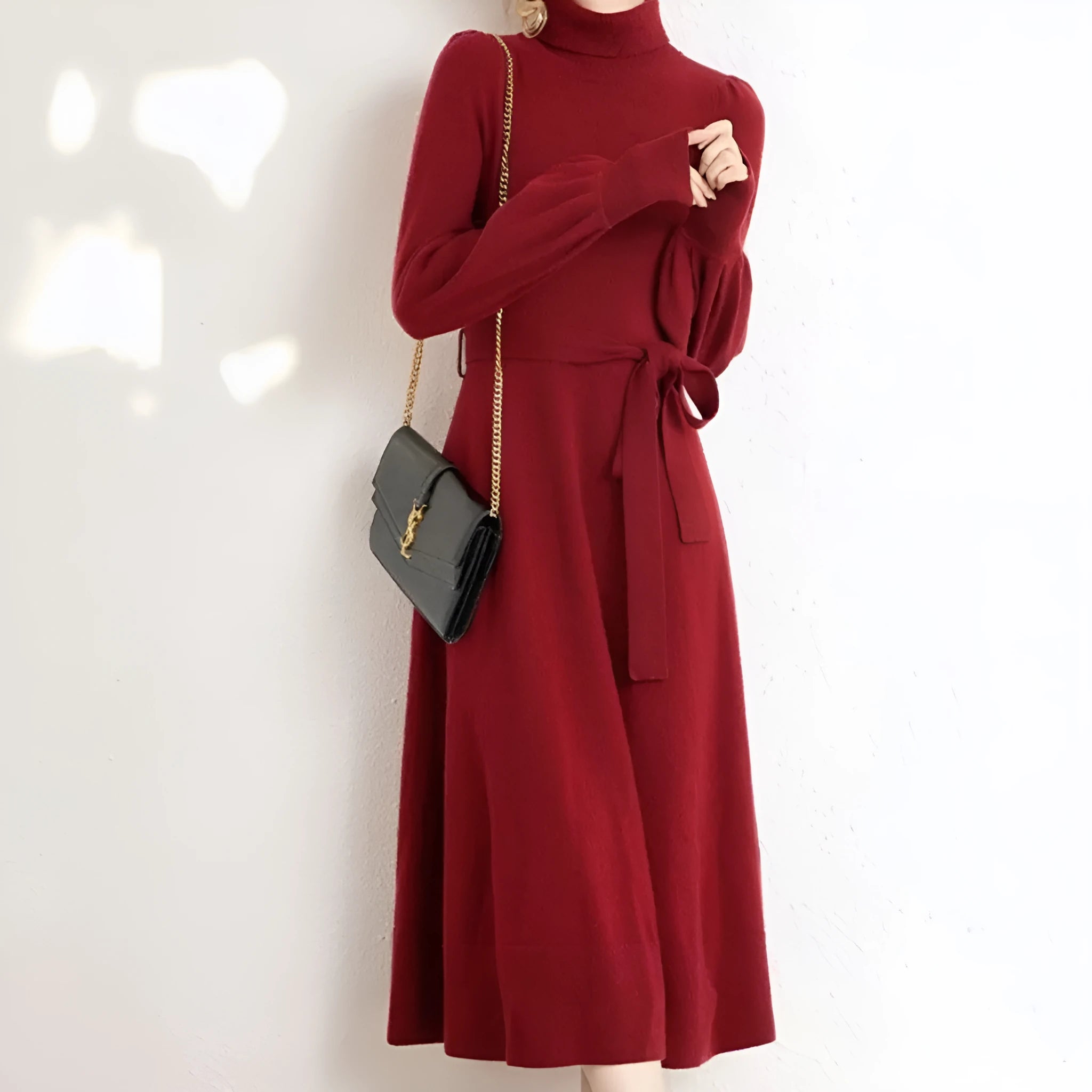 Women's knitted turtleneck dress with long sleeves, elastic waist, and a loose A-line skirt in a solid colour.