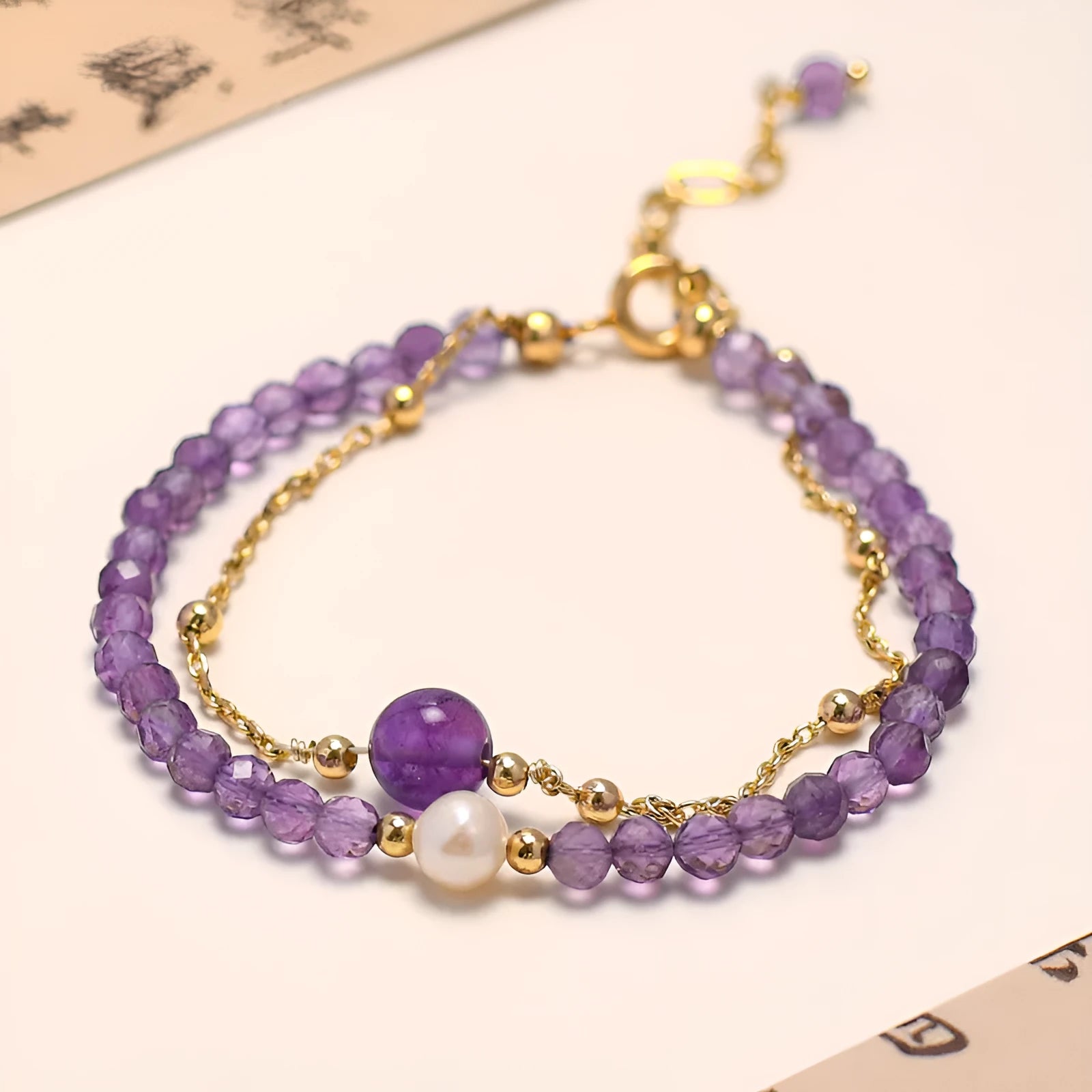 Chinese style women's bracelet with amethyst diamond-shaped crystals and electroplated finish.